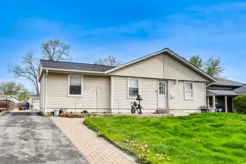 a front view of house with yard and green space