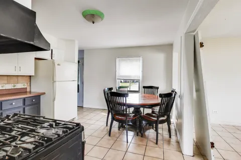 a kitchen with a table and chairs in it