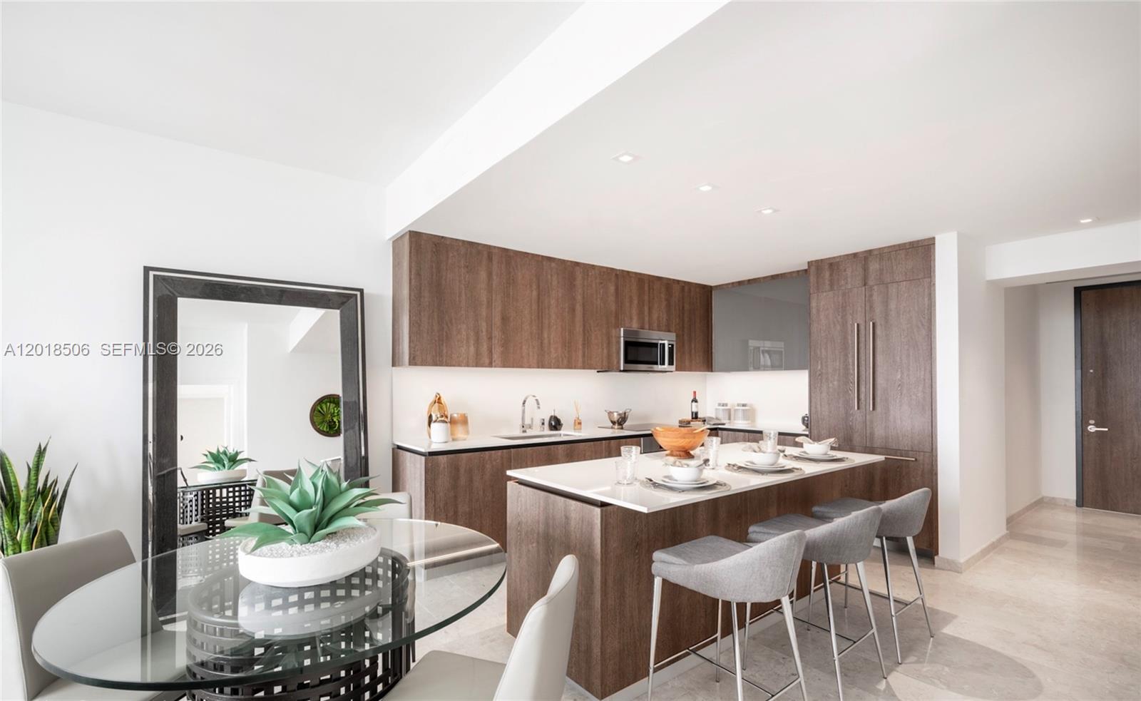 88 Southwest 7th Street, Unit 2406 Miami, FL 33130 - Photo 1 of 1 a kitchen with a dining table and chairs