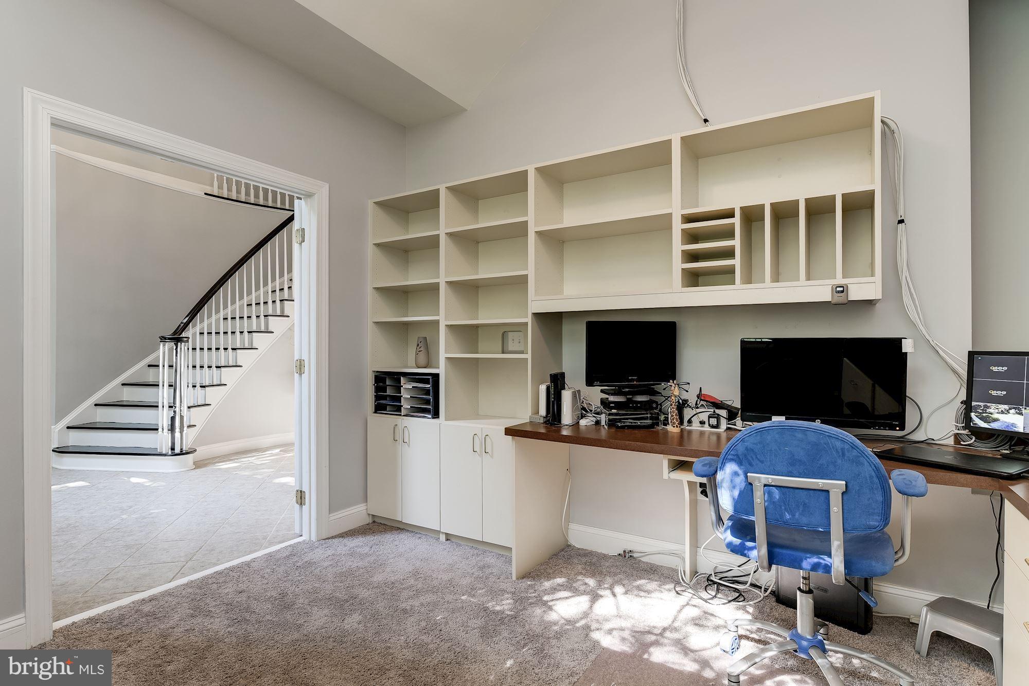 Office boasts wraparound built-in desk and shelves