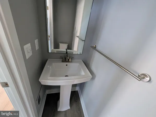 a bathroom with a double vanity sink toilet and a mirror