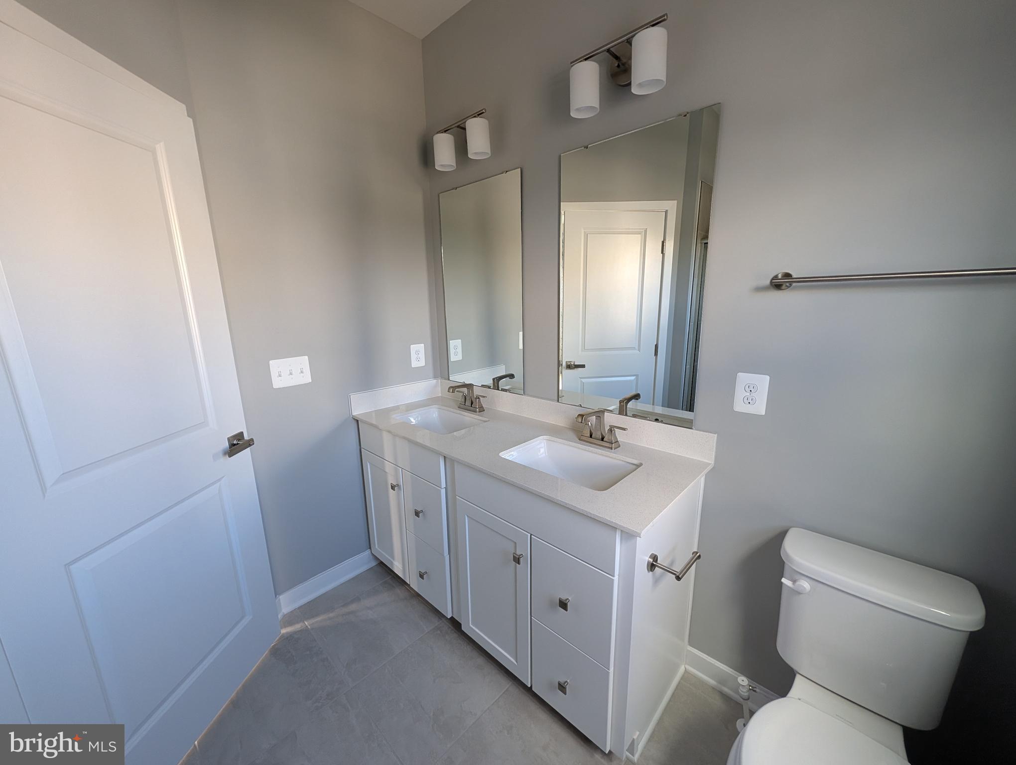 8445 Hamlin Street Lanham, MD 20706 - Photo 17 of 22 a bathroom with a double vanity sink and mirror