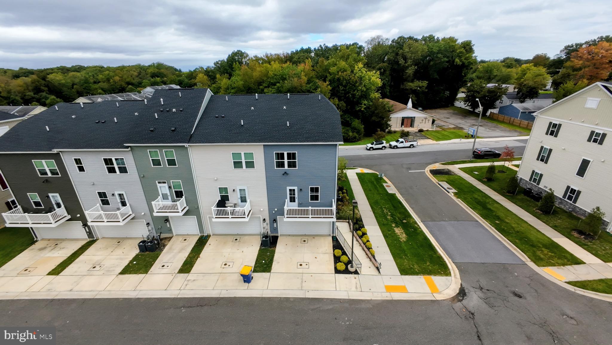 8445 Hamlin Street Lanham, MD 20706 - Photo 3 of 22 an aerial view of pool with lawn chairs and large tree