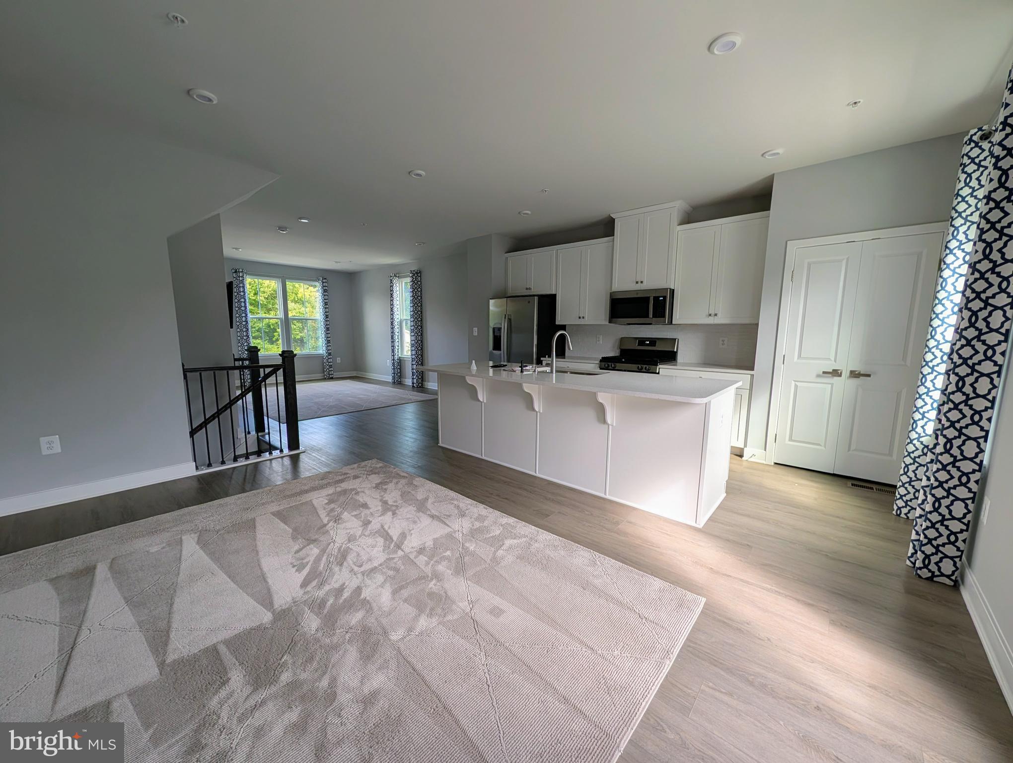 8445 Hamlin Street Lanham, MD 20706 - Photo 4 of 22 a living room with furniture and a kitchen