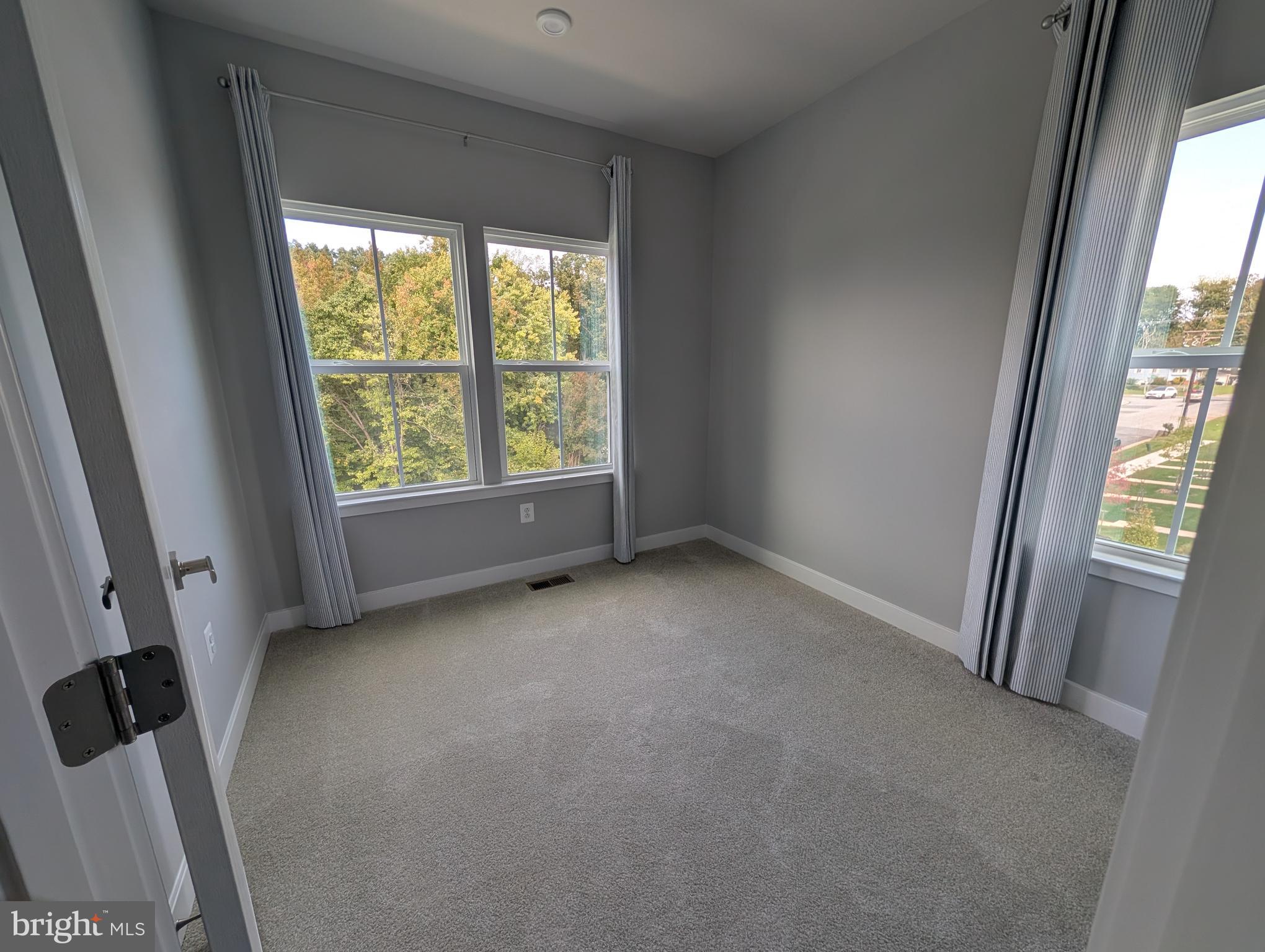 8445 Hamlin Street Lanham, MD 20706 - Photo 9 of 22 a view of an empty room with a window