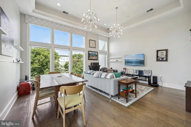 a living room with furniture a table and a large window