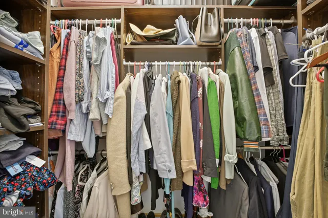 a view of walk in closet with clothes