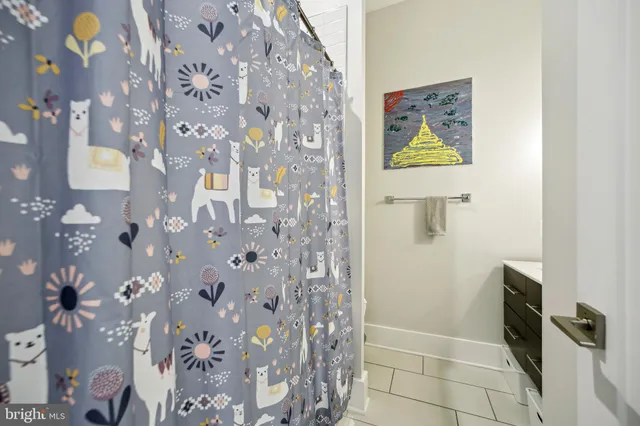 a bathroom with a shower and a sink