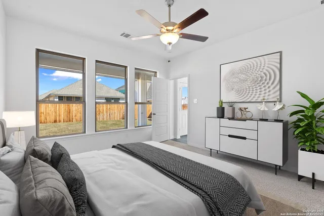 a spacious bedroom with a large bed and a window