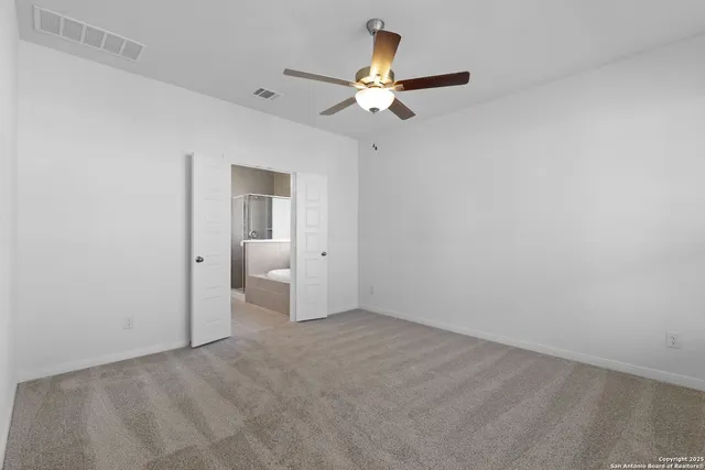 a view of an empty room with a fan