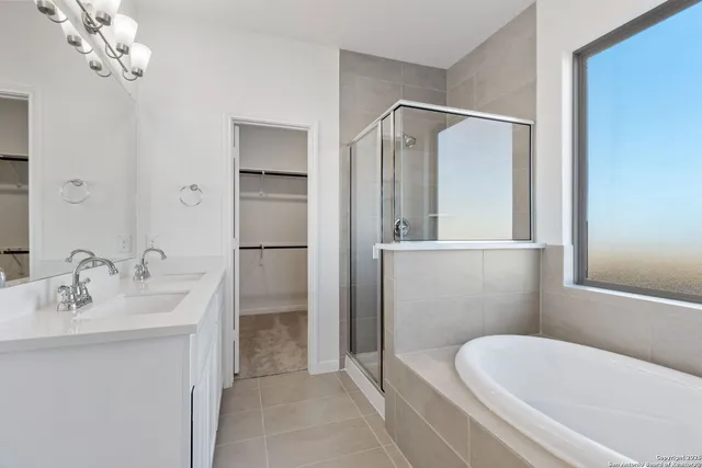 a bathroom with a bathtub shower sink and mirror