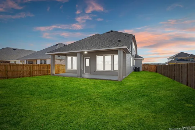 an aerial view of a house with a mountain