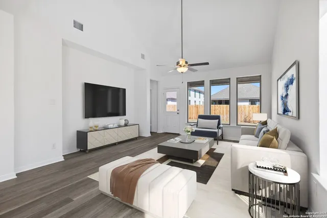 a bedroom with furniture and a flat screen tv