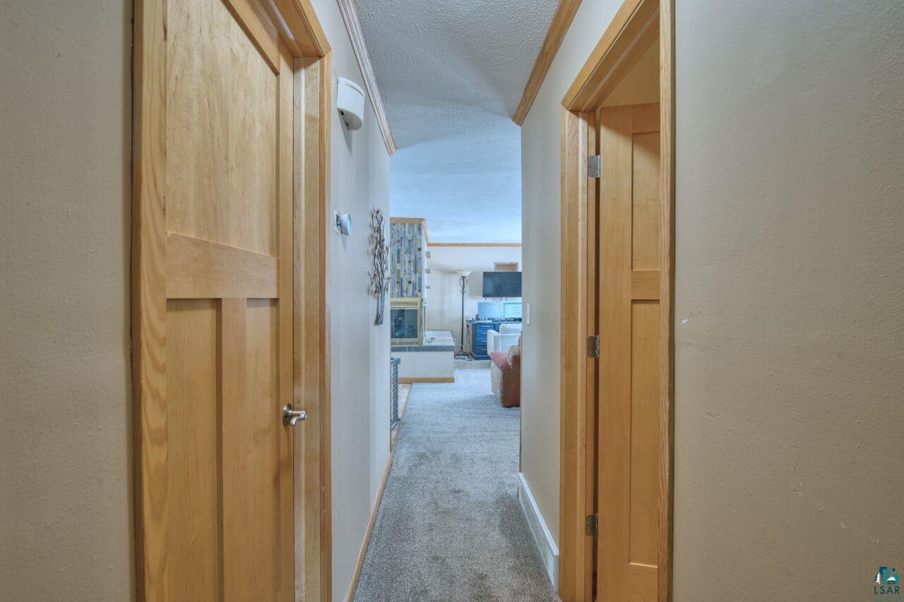 203 Wyandotte Road Hoyt Lakes, MN 55750 - Photo 14 of 39 Hall featuring carpet and a textured ceiling