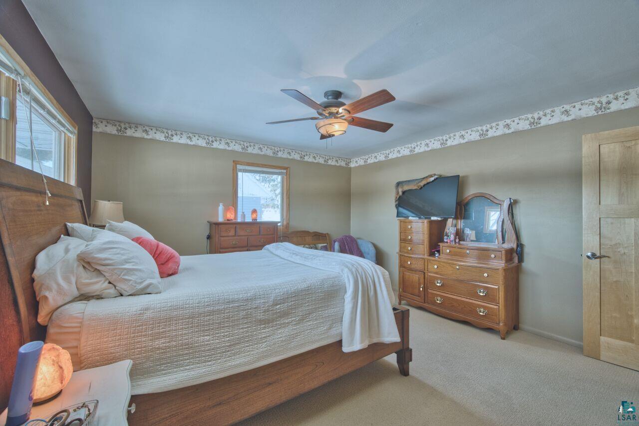 203 Wyandotte Road Hoyt Lakes, MN 55750 - Photo 18 of 44 Bedroom featuring light carpet and a ceiling fan