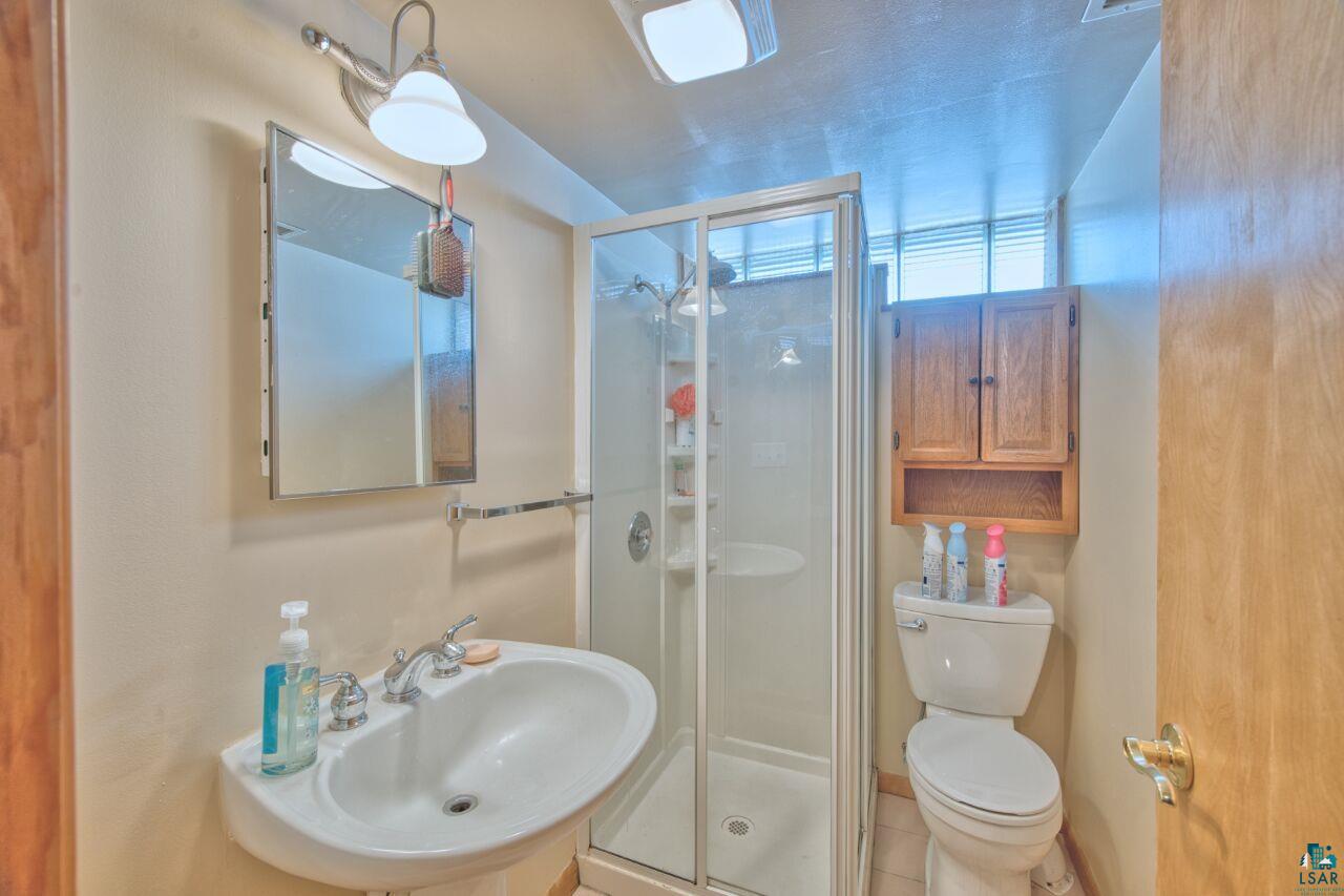 203 Wyandotte Road Hoyt Lakes, MN 55750 - Photo 25 of 39 Bathroom featuring a stall shower and light tile patterned floors