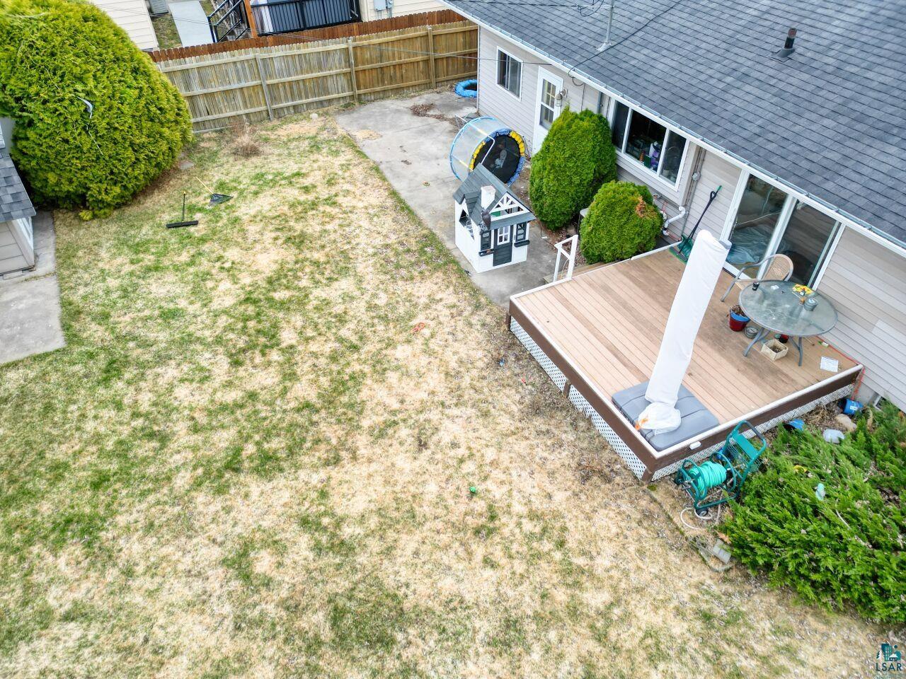 203 Wyandotte Road Hoyt Lakes, MN 55750 - Photo 30 of 39 Rear exterior featuring a composite deck, a sliding glass door, and a fenced yard