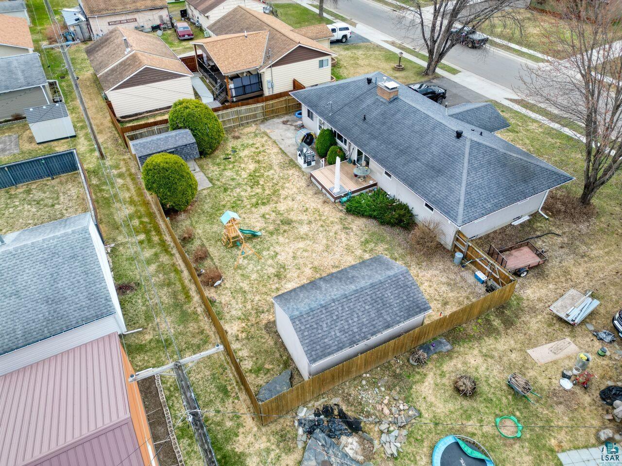 203 Wyandotte Road Hoyt Lakes, MN 55750 - Photo 35 of 39 Expansive backyard featuring a large shed, wood fence, and a multi-level wood-finish deck
