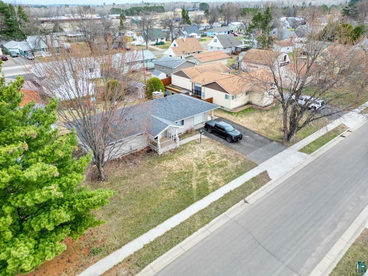 203 Wyandotte Road Hoyt Lakes, MN 55750 - Photo 38 of 39 Single-level residence featuring a gray shingle roof, light-toned siding, and a covered front porch with white railing