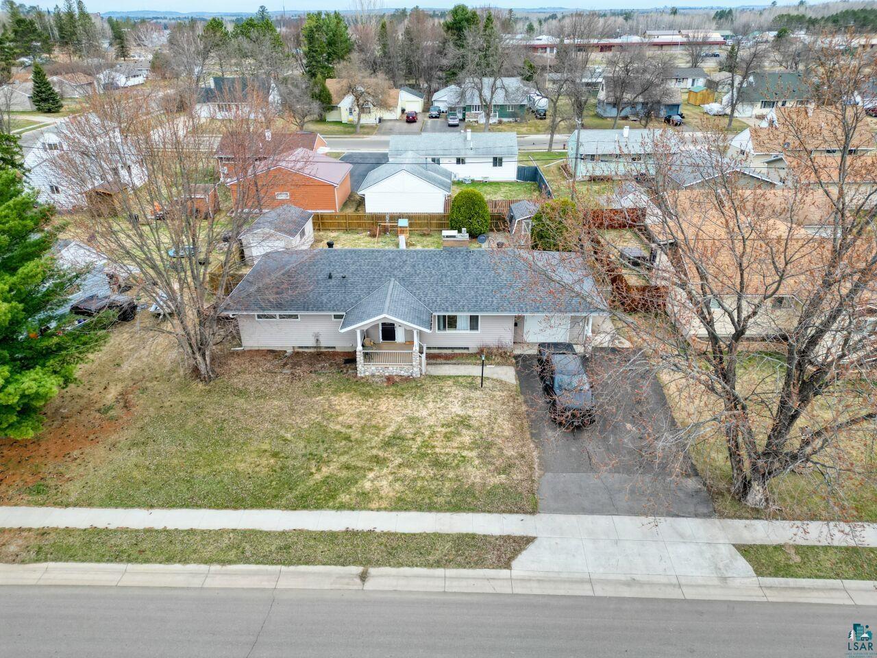 203 Wyandotte Road Hoyt Lakes, MN 55750 - Photo 39 of 39 Ranch-style residence featuring a dark shingle roof, light-toned siding, and a covered front porch with stone accents