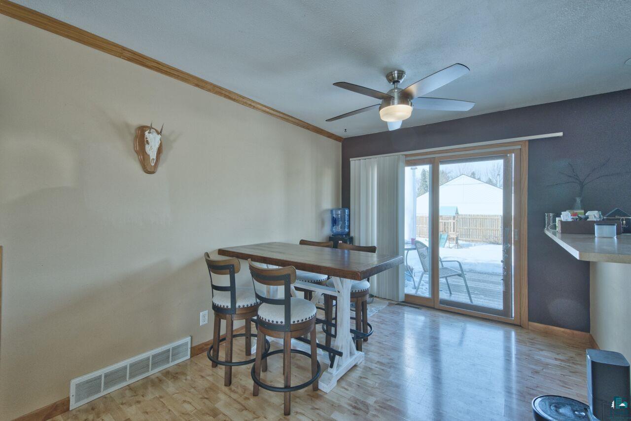 203 Wyandotte Road Hoyt Lakes, MN 55750 - Photo 8 of 44 Dining area with light wood-style floors, ceiling fan, and crown molding