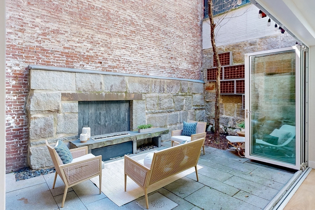 9 Chestnut Street Boston, MA 02108 - Photo 14 of 42 an outdoor living area with furniture and a fireplace