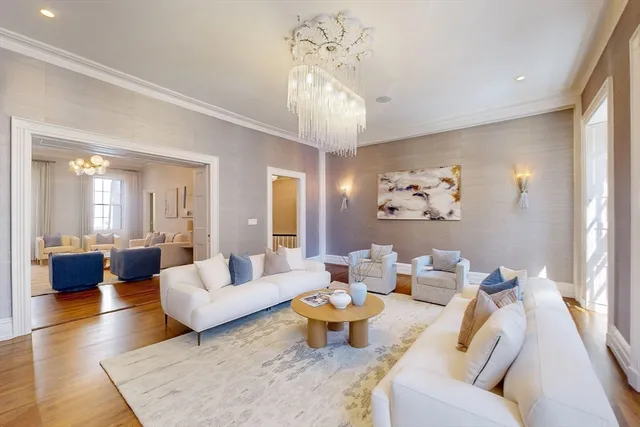 a living room with furniture and a chandelier