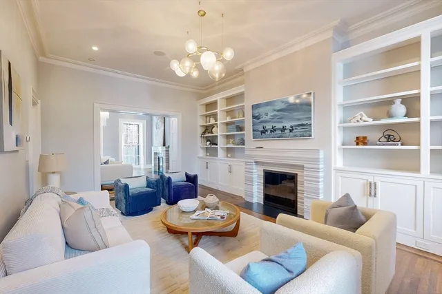 a living room with furniture fireplace and a chandelier