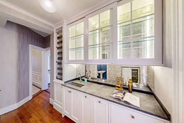 a kitchen with granite countertop a sink and a stove next to a window