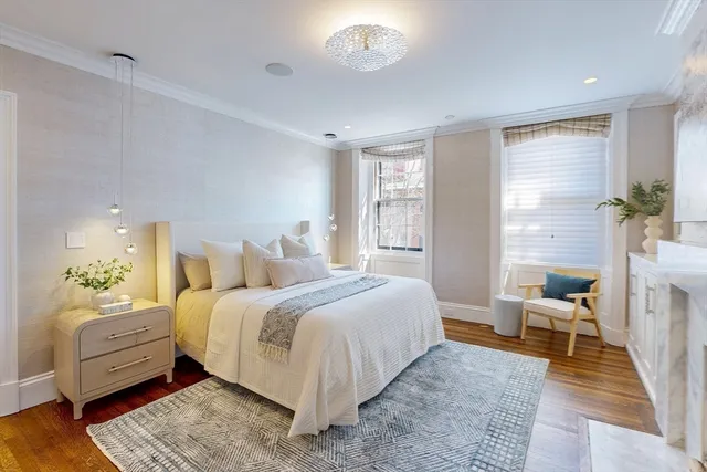 a bedroom with a bed wooden floor and a window
