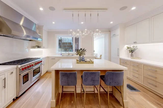 a kitchen with a table chairs stove and cabinets