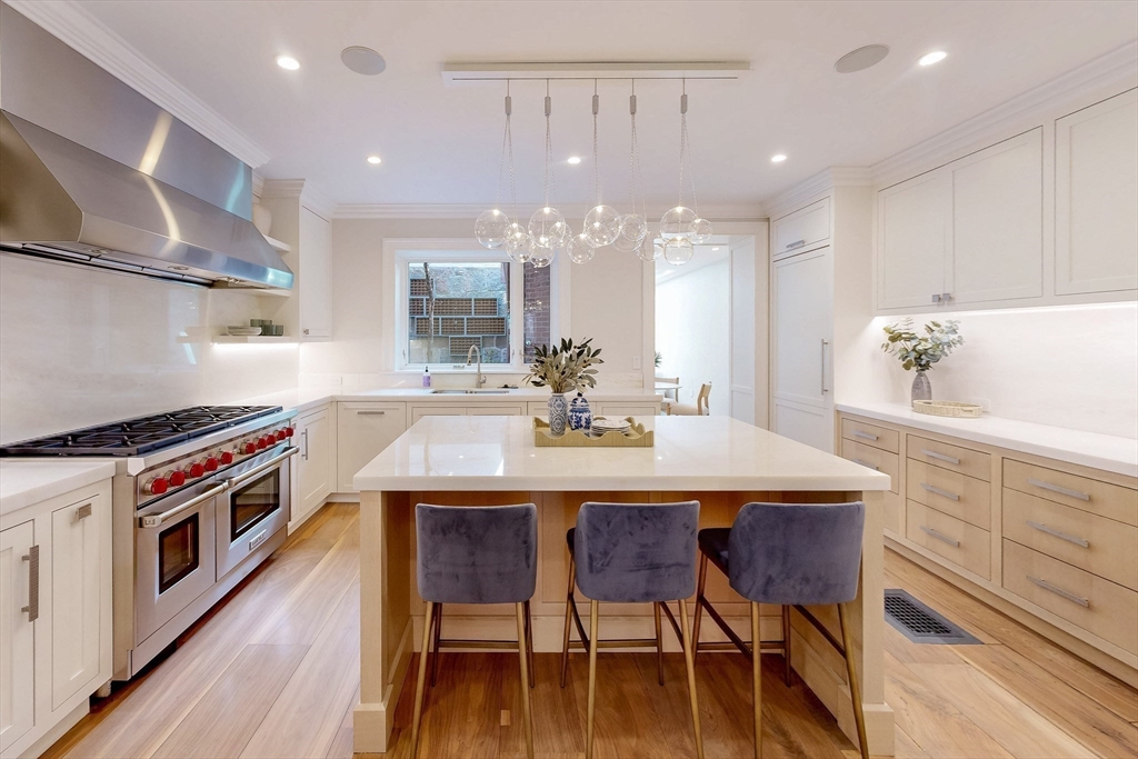 9 Chestnut Street Boston, MA 02108 - Photo 7 of 42 a kitchen with a table chairs stove and cabinets