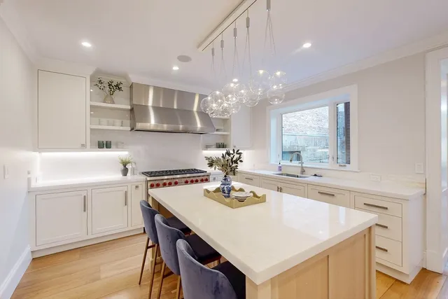 a kitchen with a sink center island and cabinets