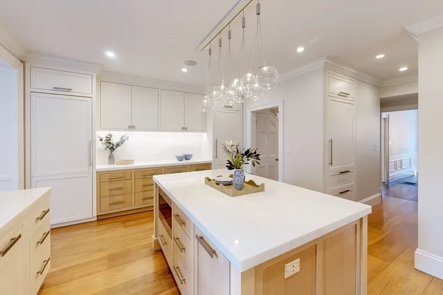 a kitchen with a sink a stove a refrigerator and cabinets