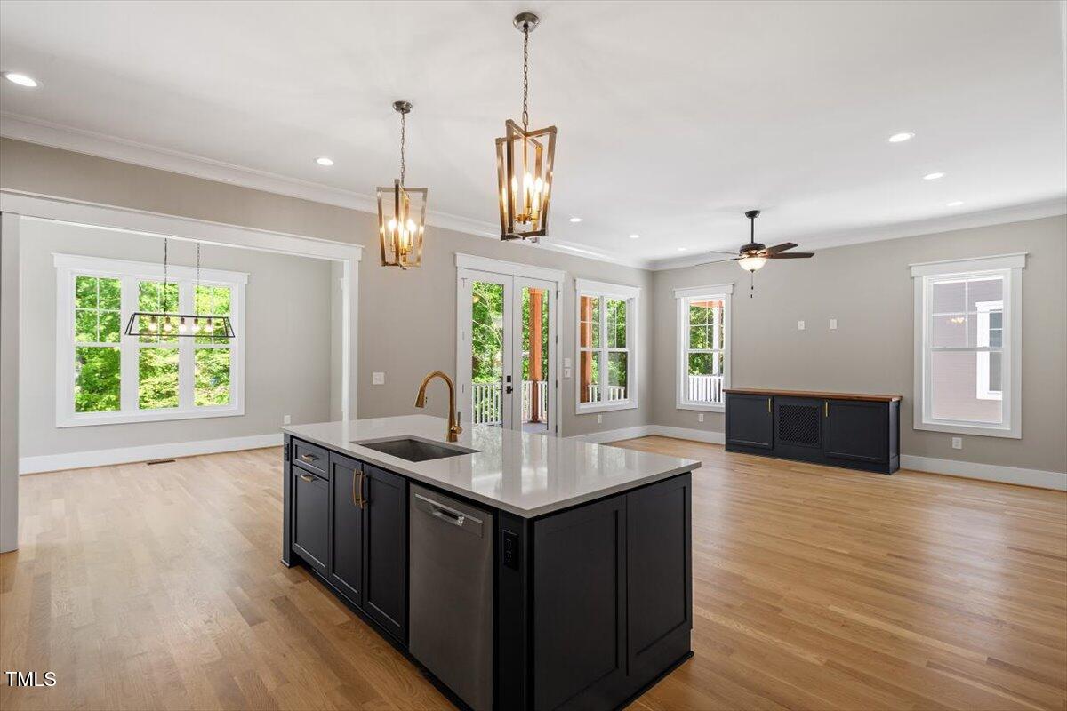3934 Old Chapel Hill Road Durham, NC 27707 - Photo 18 of 47 a kitchen with stainless steel appliances granite countertop wooden floors sink and window