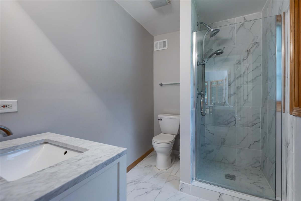 872 Rosedale Terrace Crete, IL 60417 - Photo 27 of 54 a bathroom with a granite countertop sink a toilet and shower
