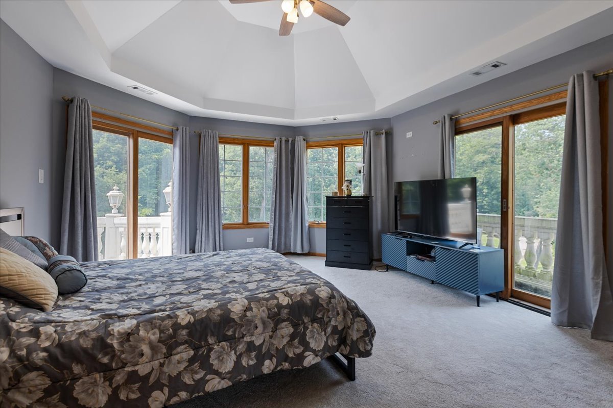 872 Rosedale Terrace Crete, IL 60417 - Photo 43 of 54 a bedroom with a bed and a flat tv screen next to a large window