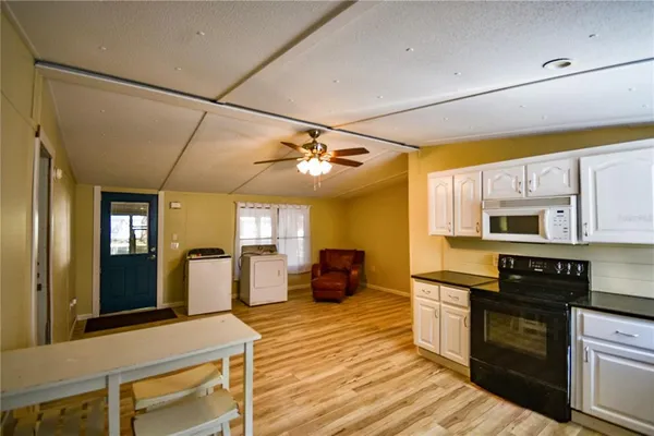 a kitchen with stainless steel appliances a stove sink and microwave