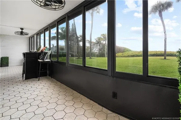 an aerial view of ocean and residential houses with outdoor space