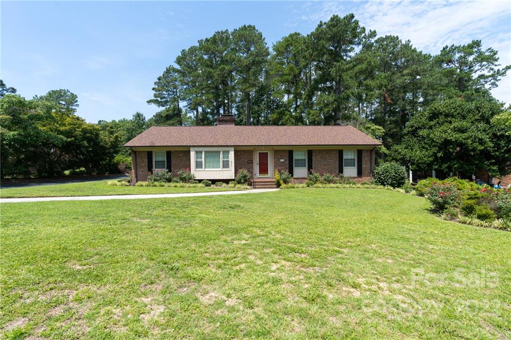 311 Curtis Drive Rockingham, NC 28379 - Photo 2 of 40 a front view of a house with a yard table and chairs
