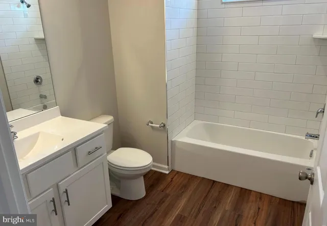 a bathroom with a sink a toilet and bathtub