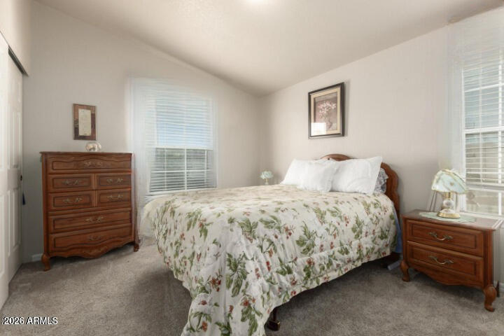 3301 South Goldfield Road, Unit 4086 Apache Junction, AZ 85119 - Photo 14 of 41 a bedroom with a bed and a closet