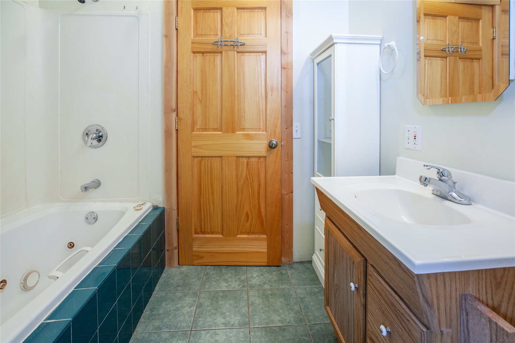 498 D Road Silverthorne, CO 80498 - Photo 28 of 49 Bathroom with tile patterned floors, tiled bath, and vanity jetted tub