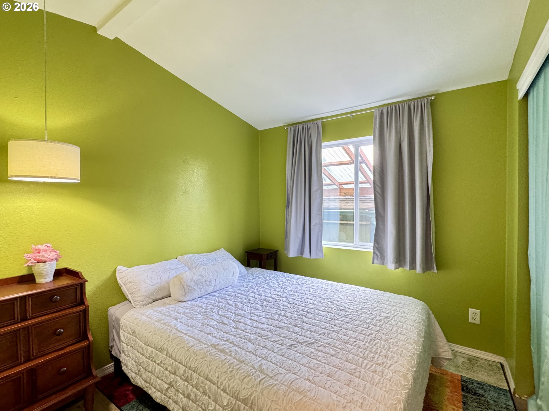 3760 Highway 101, Unit 1 Florence, OR 97439 - Photo 11 of 32 a bedroom with a bed and large windows