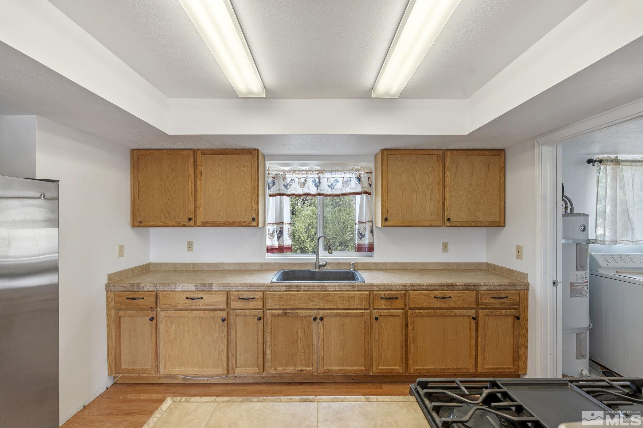150 Red Corral Trail Reno, NV 89510 - Photo 11 of 40 a kitchen with sink cabinets and window