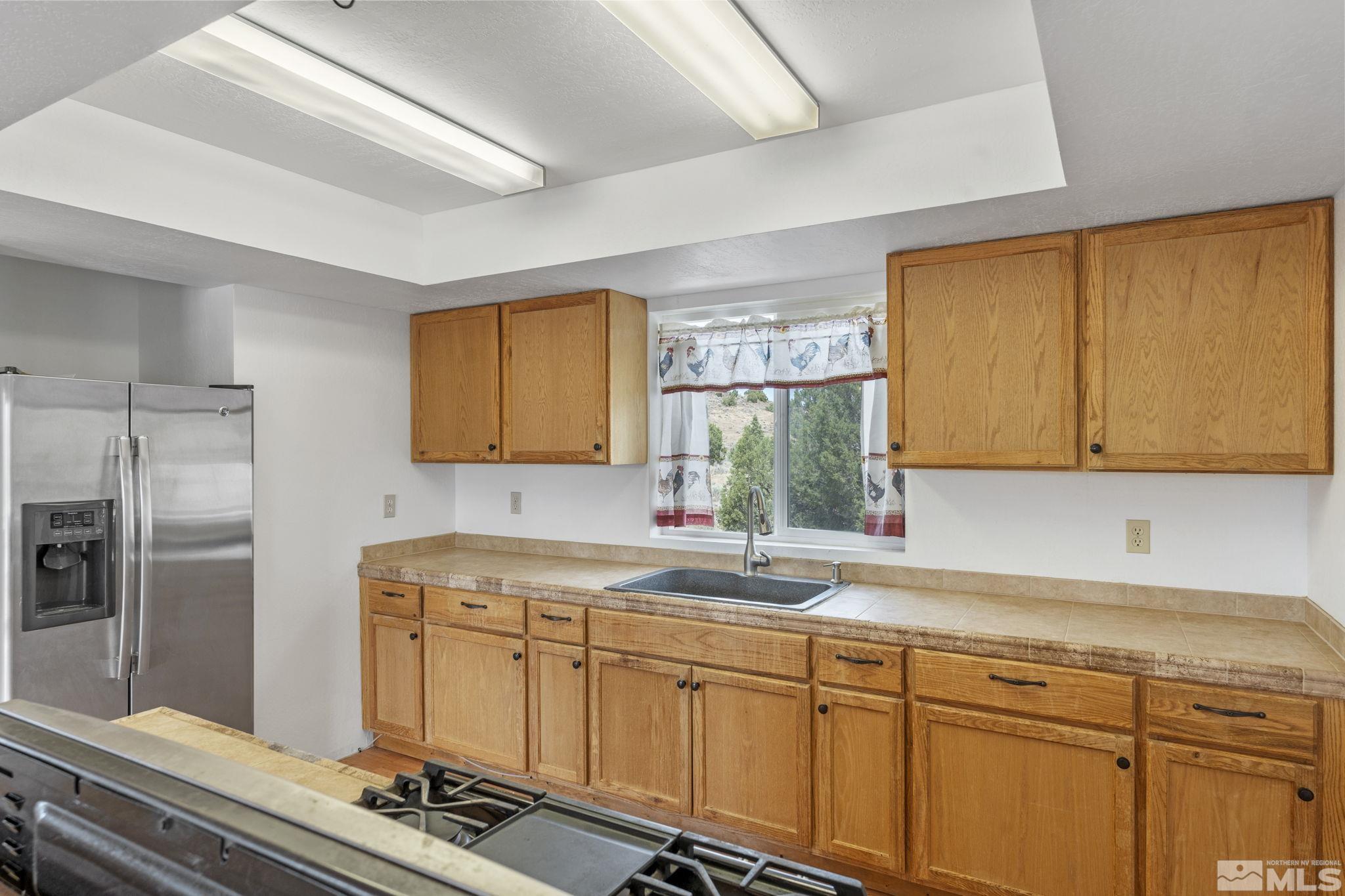 150 Red Corral Trail Reno, NV 89510 - Photo 14 of 40 a kitchen with a sink appliances and cabinets