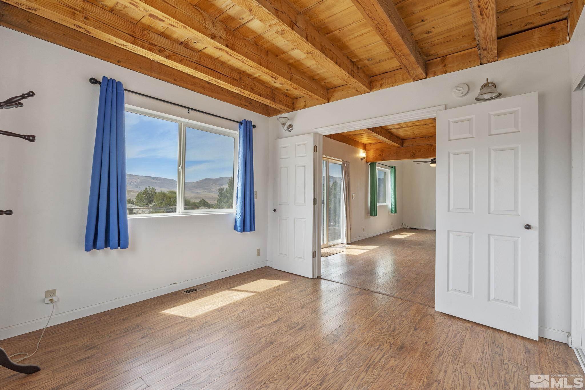 150 Red Corral Trail Reno, NV 89510 - Photo 16 of 40 a view of an empty room with wooden floor and a window