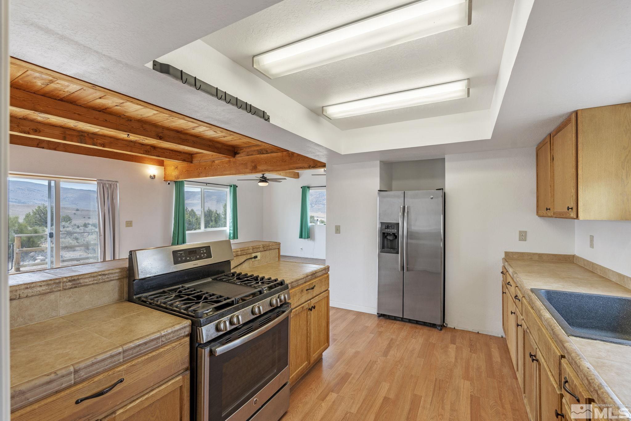 150 Red Corral Trail Reno, NV 89510 - Photo 10 of 40 a kitchen with a stove a refrigerator and a sink