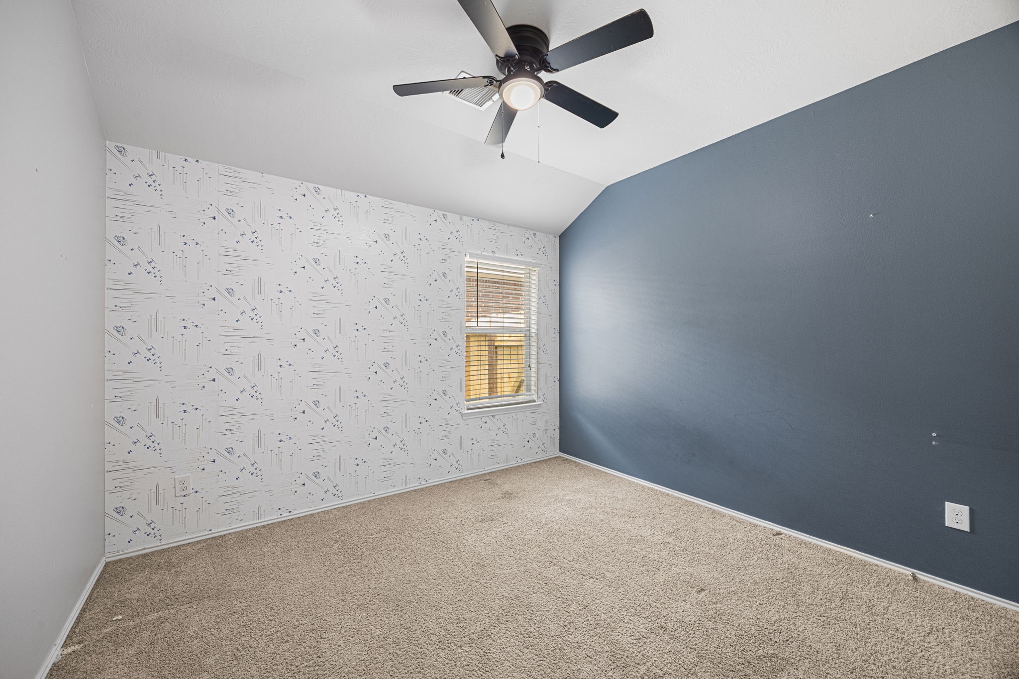 2211 Oak Rise Drive Conroe, TX 77304 - Photo 21 of 29 Bedroom with ceiling fan and accent wall