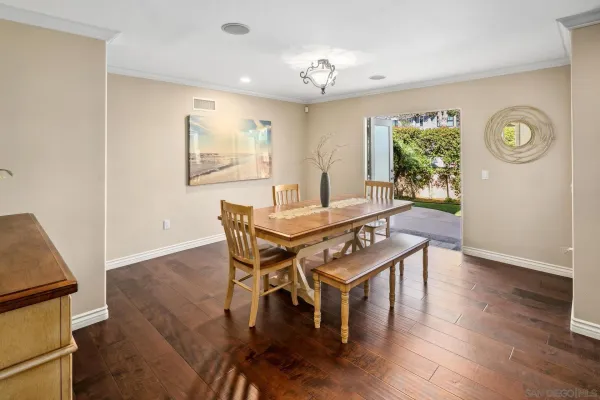 a view of a dining room with furniture and wooden floor